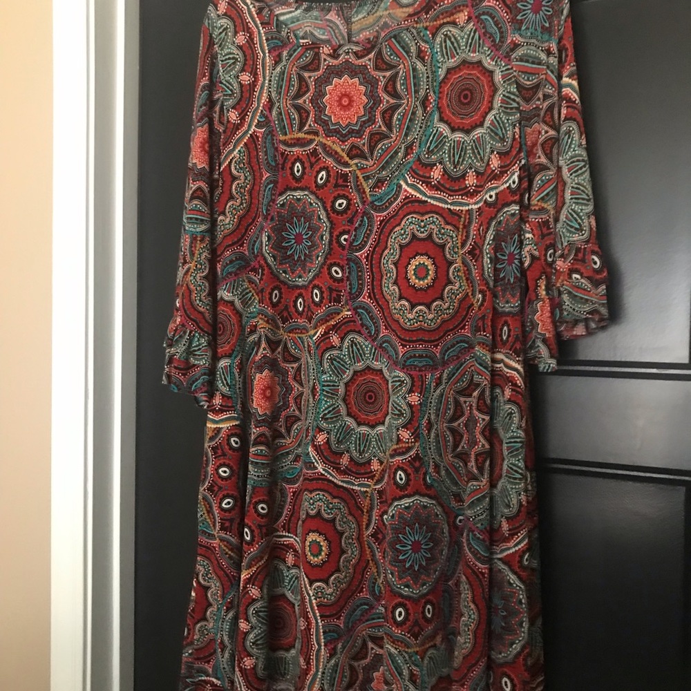 Slightly above the Knee length dress 3/4 length sleeves and pockets.